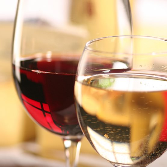 Close up of two wine glasses, one with red wine and the other with white wine
