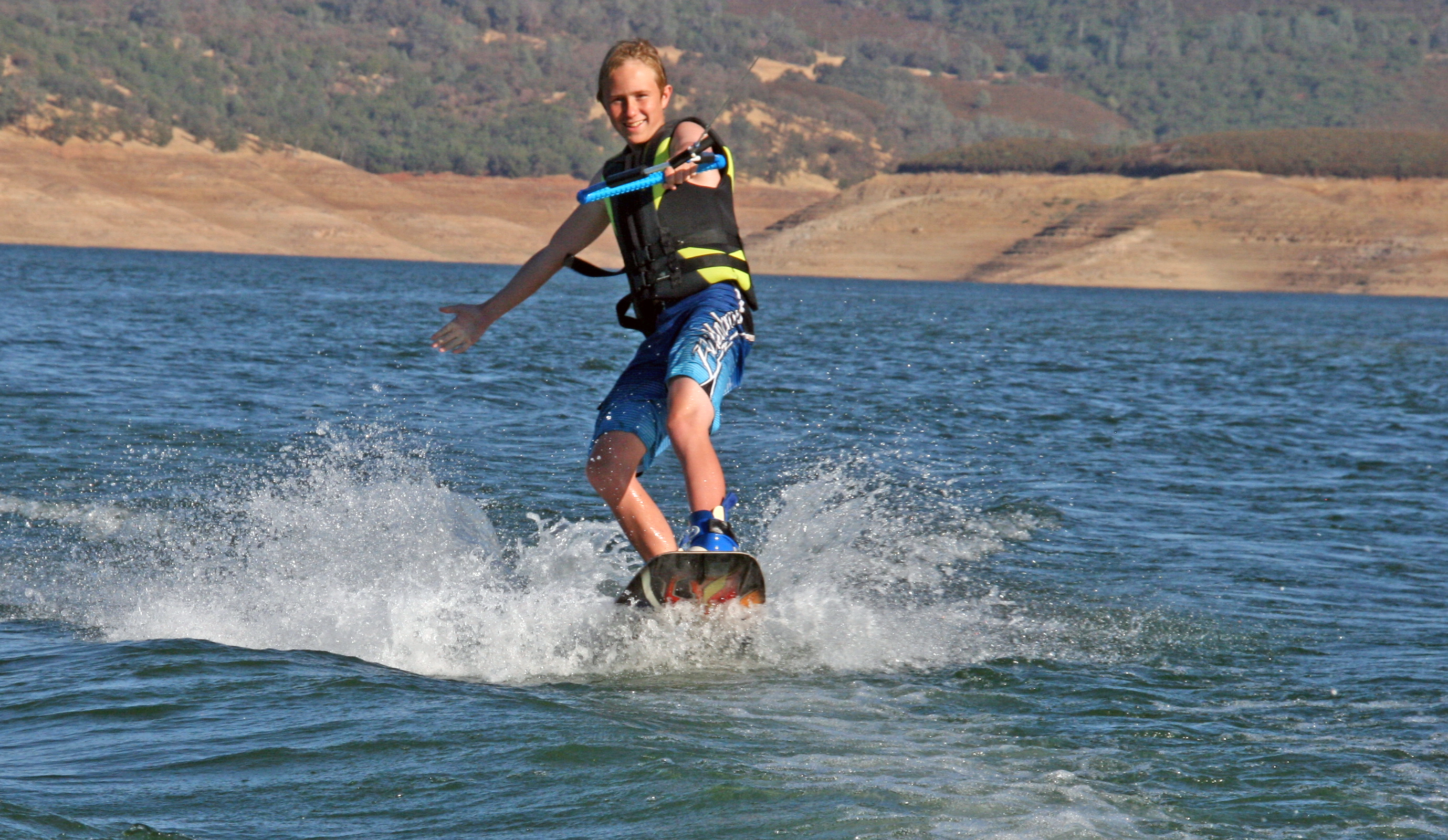 new melones lake marina boy water skiing in summer